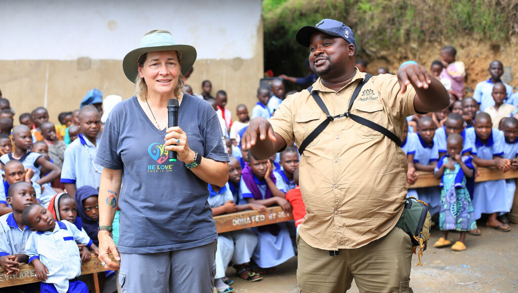 Rev Karen Fry and a travel partner speak to assembled children at the Murushasha School in Uganda 