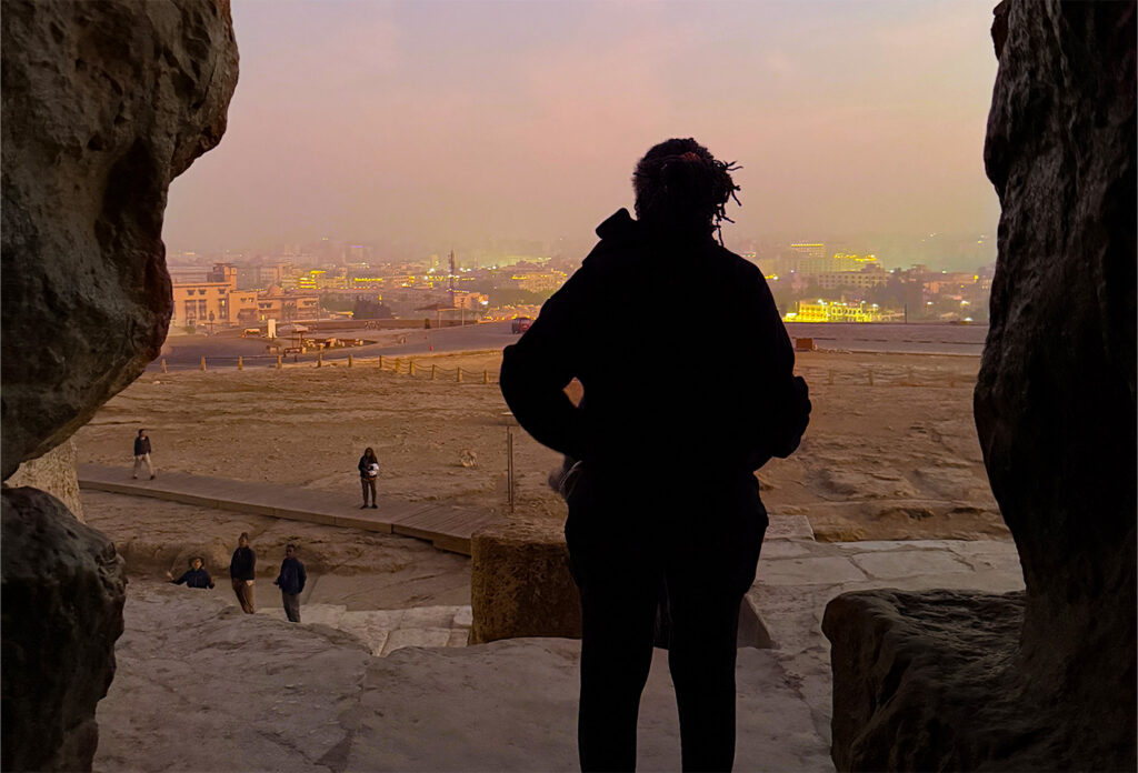 Spirit Tours traveler looking out from the Great Pyramid of Giza at dawn during an Egypt journey